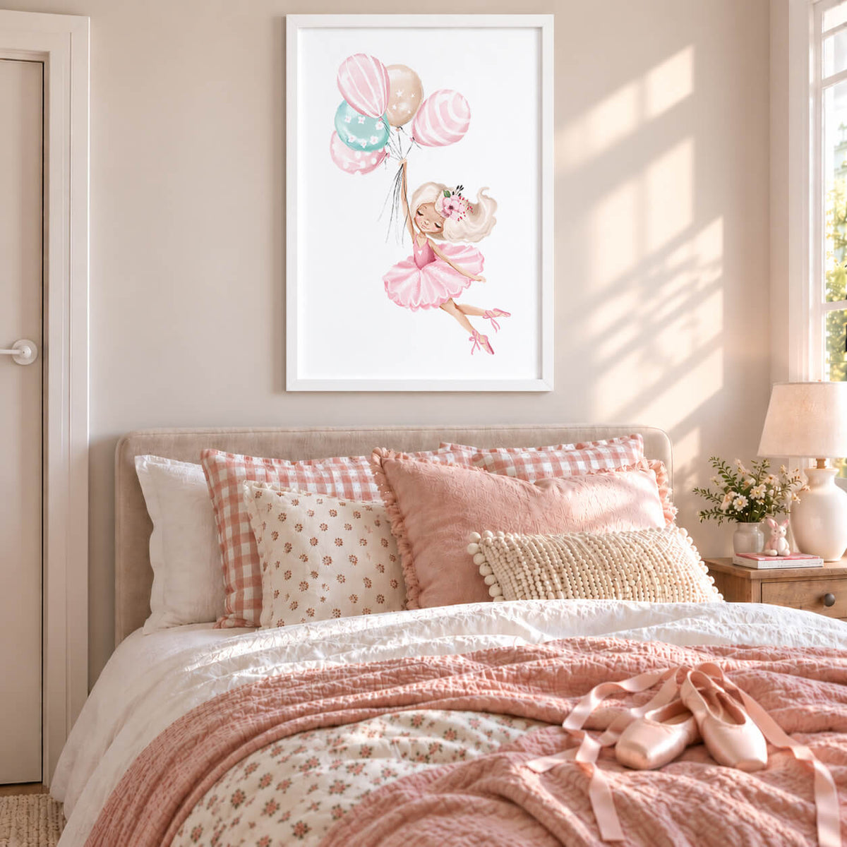 White Frame: Ballerina wall art print featuring a whimsical pink ballet dancer with pastel balloons, displayed in a white frame in a girls bedroom.
