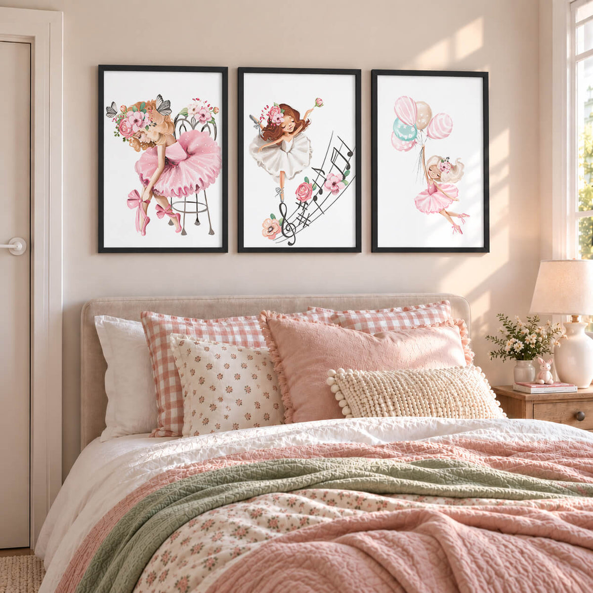 A set of black white framed wall art prints featuring illustrations of ballerinas, mounted on a wall above a bed in a child's bedroom.