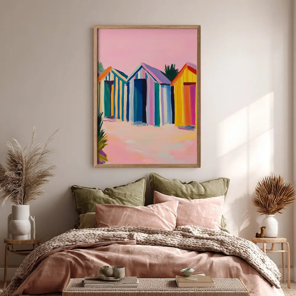 Colourful beach huts coastal wall art print in warm pink and blue tones.