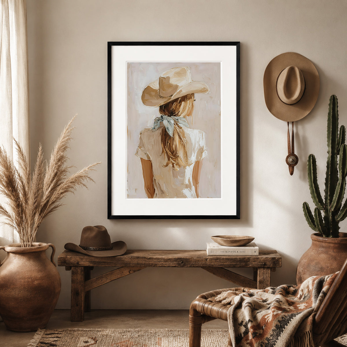 Minimalist cowgirl wall art print in an black frame displayed in a western room, featuring a neutral western portrait with a cream scarf and light blue bandana.