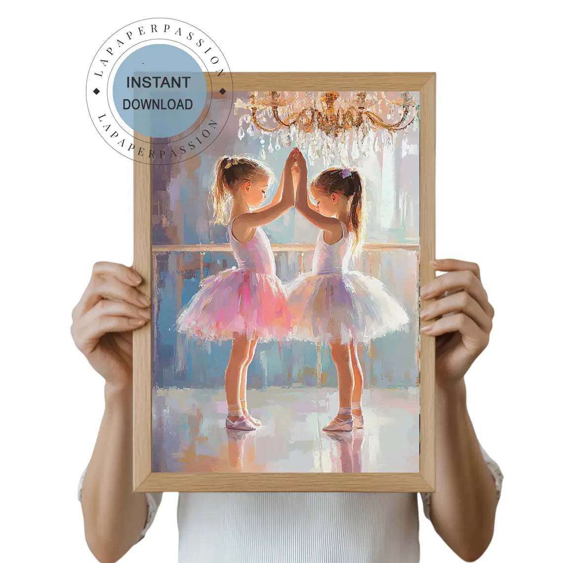 Two young ballerinas in pink and white tutus touching hands in a dance studio under a chandelier