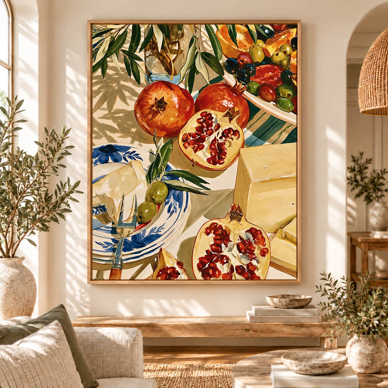 Mediterranean framed canvas wall art featuring red pomegranates, green olives, citrus fruit and cheese in a colourful vintage still life painting.