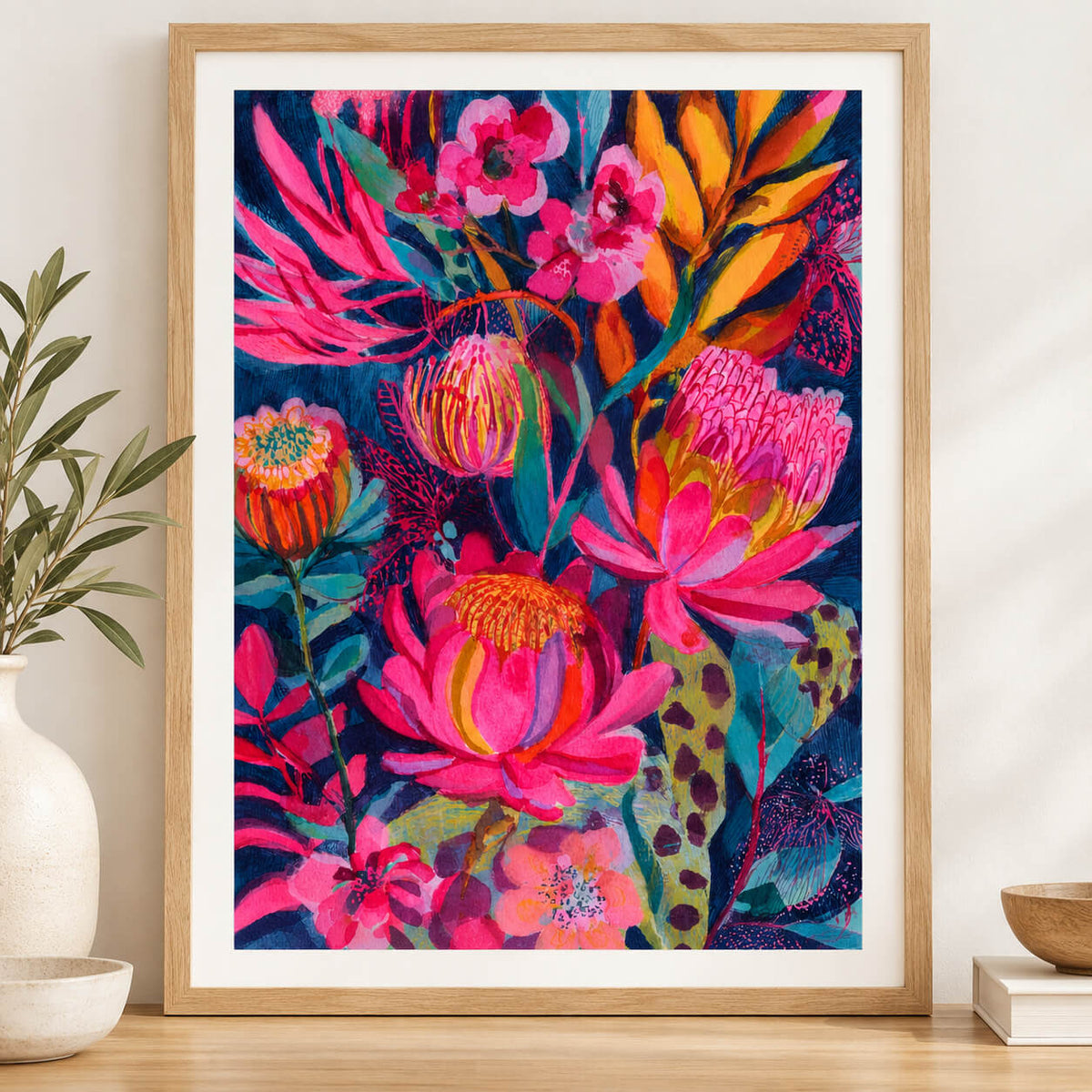 Colourful Australian botanical wall art print with pink protea flowers, orange native blooms and tropical foliage on a dark navy background.