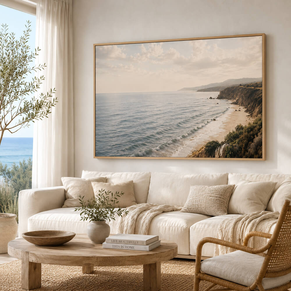 Coastal cliffs wall art featuring a peaceful ocean shoreline with rolling waves, golden cliffs and a soft sunlit sky, available as a premium framed canvas 