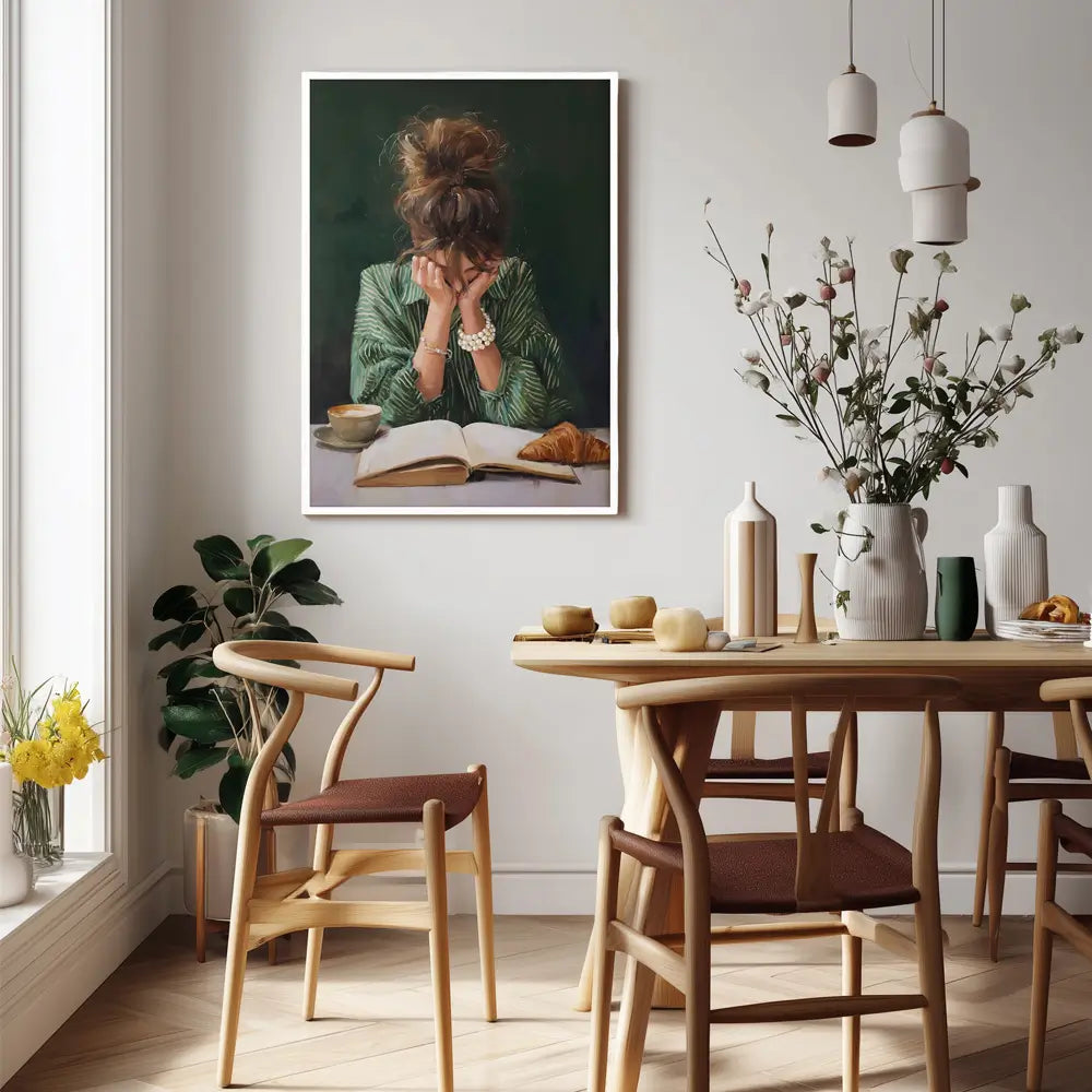 emerald green wall art print of woman reading with coffee and croissant framed in white