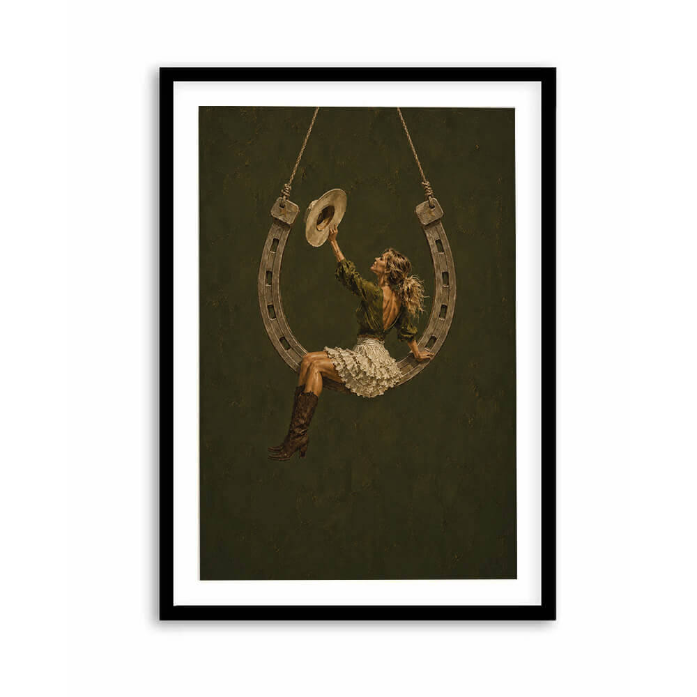 Cowgirl horseshoe wall art featuring woman sitting on a hanging horseshoe swing
