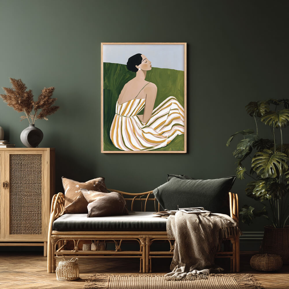 Minimalist wall art print of a seated woman in a striped summer dress, framed in natural oak, enhancing modern home decor.